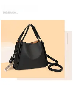Detail of black lychee grain leather tote bag with silver hardware and adjustable strap