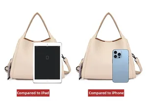 Size comparison of the cream leather bucket bag with an iPad and iPhone for scale