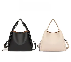 Side-by-side view of black and off-white large capacity pebbled leather tote bags