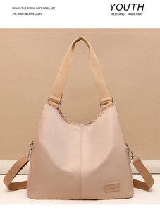 Front view of large capacity nude pink waterproof nylon tote bag with wide handles