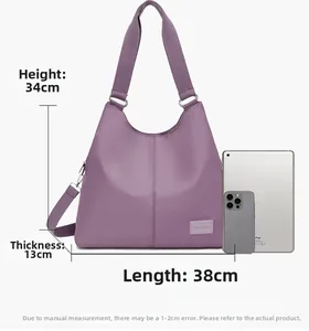 Detail view of large purple nylon tote bag with 38cm width and tablet for size scale