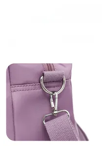 Detail of durable nylon fabric with silver metal D-ring and detachable purple strap