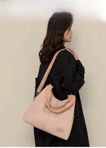Detail of light pink waterproof nylon tote bag with wide adjustable shoulder strap