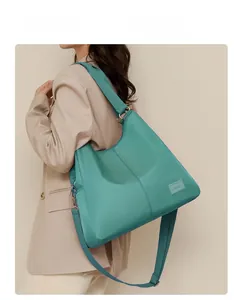 Detail of mint green waterproof nylon tote bag with texture strap and metallic buckle