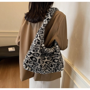 Vue détaillée d'un sac hobo en peluche léopard porté sur un manteau d'automne chic
