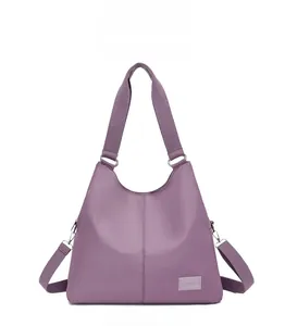 Front view of large purple waterproof nylon tote bag with wide textile strap