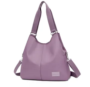 Detailed side view of purple nylon tote bag featuring durable straps and adjustable strap