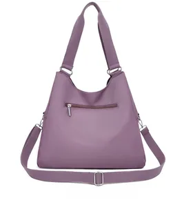 Detail view of the purple nylon tote bag back with a functional horizontal zipper pocket