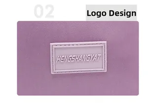 Close-up of silicone brand logo plate and fine stitching on purple nylon tote bag