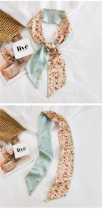 Détail d'un twilly en soie double face montrant des motifs abstraits vert menthe et beige