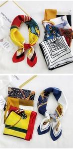 Detail showing various silk texture printed square scarves with equestrian and floral patterns