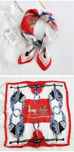 Detail of red and blue equestrian silk scarf showing draped and flat-lay textures