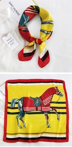 Detail of vintage equestrian square silk scarf with horse and harness print patterns