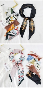 Macro detail of various patterned silk twilly scarves with elegant floral and celestial prints