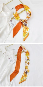 Detailed close-up of double-sided twilly silk scarf with yellow floral and script prints