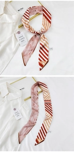 Detail of pink and orange striped silk scarf with elegant pattern and wash label