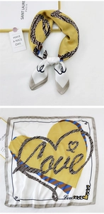 Detail of artistic heart pattern silk scarf with Love script and blue striped edges