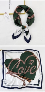 Detailed view of silk square scarf featuring heart pattern and Love artistic font