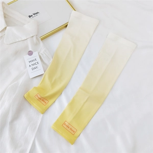 Detail of gradient cream to yellow sun sleeves with orange brand logo on a white fabric