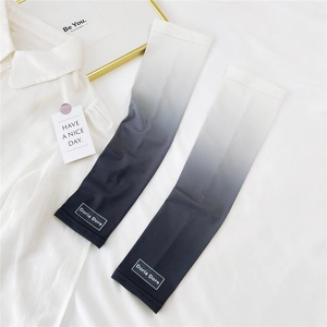 Detail view of grey gradient sun protection sleeves with breathable fabric and logo