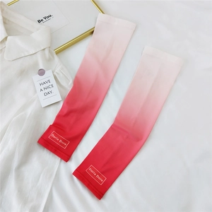 Detail of pink-to-red gradient sun sleeves with Doria Dore logo on ice silk fabric