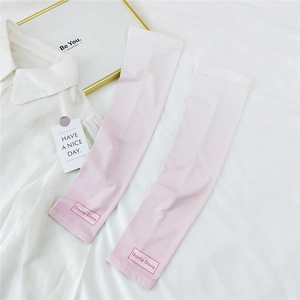 Detailed close-up of pink-white gradient sun protection sleeves with Doria Dore logo print