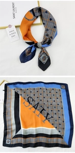 Detail of satin square scarf with orange and blue houndstooth and polka dot patterns