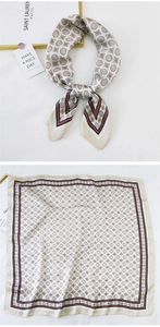 Detail view of square silk scarf with vintage badge patterns and tricolor borders