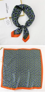 Detailed view of dark green paisley silk scarf with orange borders and classic pattern