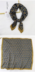 Close-up of paisley pattern silk scarf with retro gold borders and smooth texture