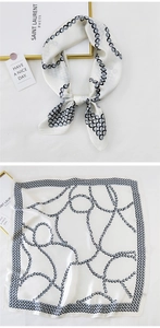 Detail view of square satin scarf featuring modern chain patterns and polka dot print