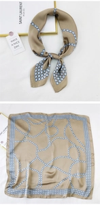 Detail of champagne silk scarf with blue pearl dot patterns showing the texture and knotting