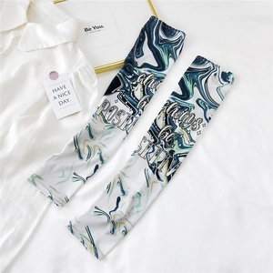 Close-up of marble pattern cooling arm sleeves with always be positive text print