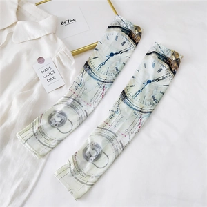 Detail of ice silk sun protection sleeves with vintage mechanical clock and Roman numerals