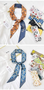 Detail view of printed narrow silk scarves with floral and fruit patterns on white shirt