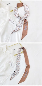Detail of floral pattern silk scarf and Positive Thinking text used as a hair tie