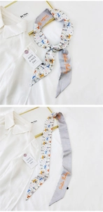 Close-up of leopard print skinny scarf with Positive Thinking embroidery on grey satin