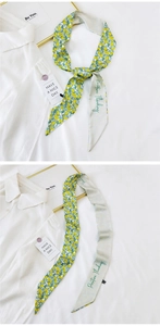 Detail of narrow silk scarf with lemon floral print and Positive Thinking text