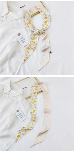 Detail showing the bird and floral pattern on a silk skinny scarf tied on a shirt