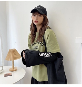 Detail of green cotton T-shirt with black MISUKH sun protection cooling sleeves