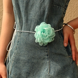 Mint green 3D chiffon flower waist chain styled on a dark denim dress for women