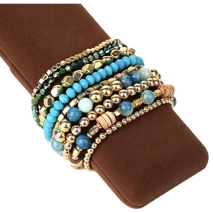9-piece blue bohemian beaded bracelet set displayed on a brown jewelry pillow display