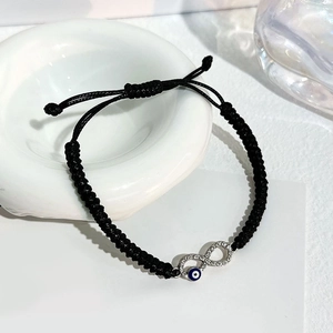 Black braided infinity evil eye bracelet with white rhinestones and blue eye bead charm