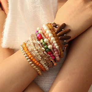 Macro detail of Bohemian stretch beaded bracelets with mixed colorful resin and wood beads