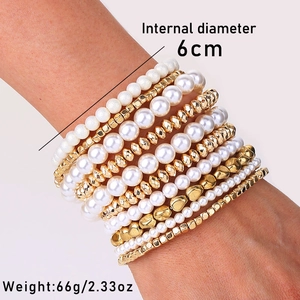 Detail view of 10-piece pearl and gold bead stretch bracelet set with 6cm inner diameter
