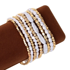 Minimalist beaded bracelet set with gold CCB beads and white faux pearls on display