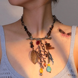 Bohemian retro bronze necklace with turquoise beads and metallic leaf pendants on a model
