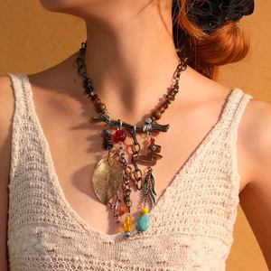 Detail of bohemian fringe necklace with vintage alloy leaves and turquoise beads