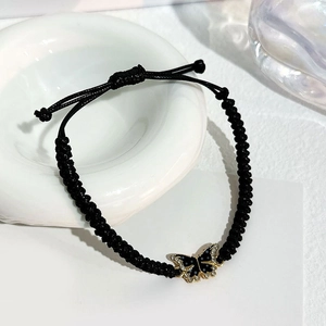 Handmade black cord bracelet featuring a crystal butterfly charm with gold trim