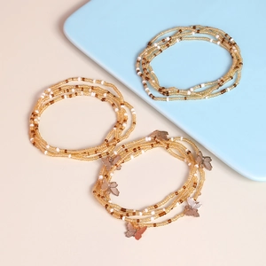 Detailed shot of handmade beaded multi-layer bracelets with golden butterfly charms